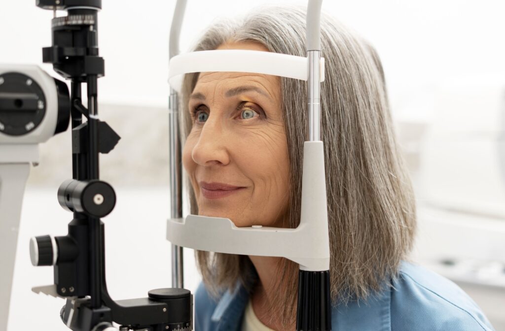 A person at an eye exam having their eyes examined by a slit lamp.