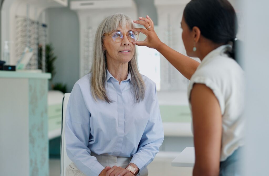 A person getting new glasses with the help of their optician from their optometrist's office in Encinitas.