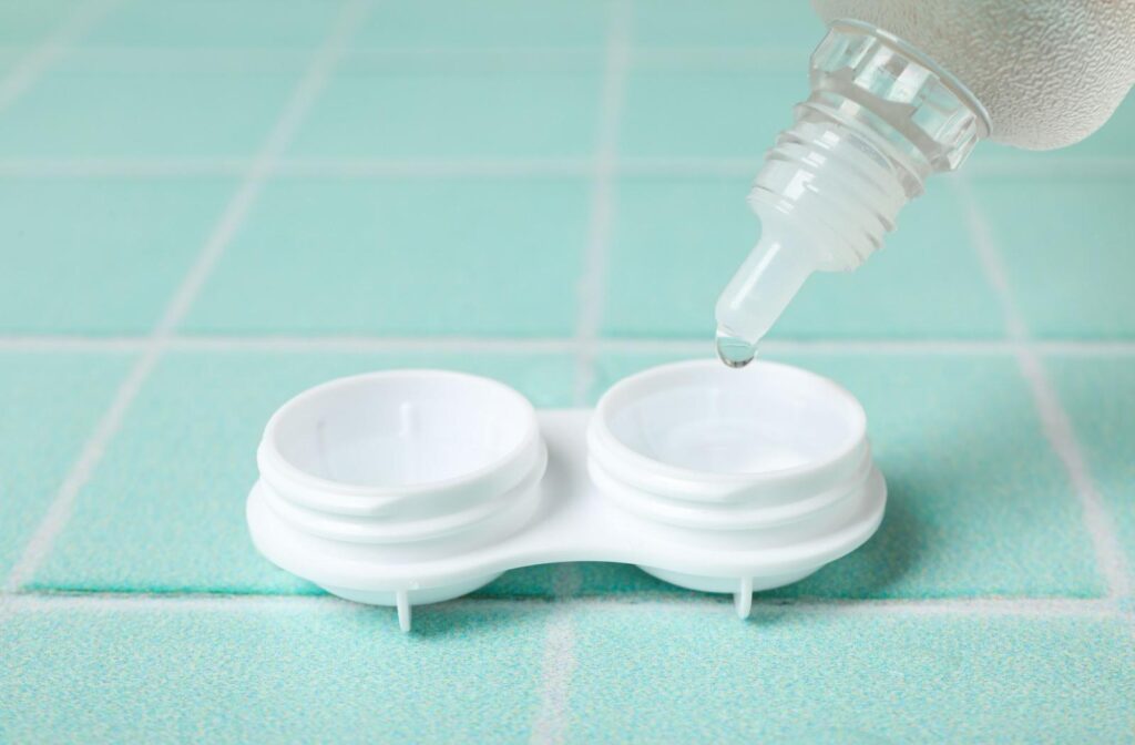 A bottle of contact lens solution being poured into a contact lens case.