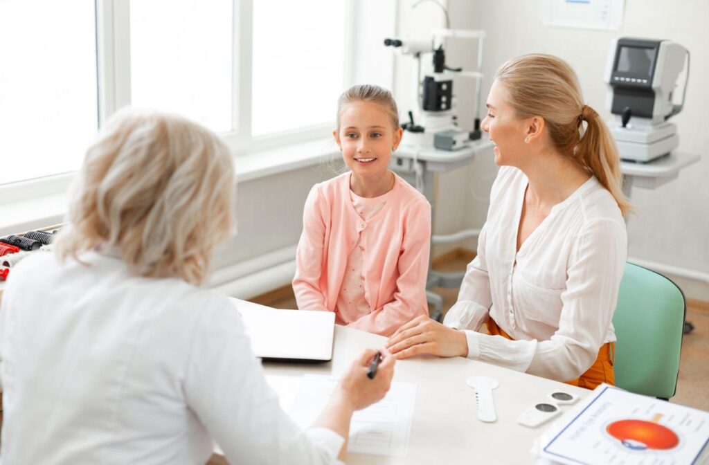 A child and parent meeting with an optometrist about myopia progression and treatment.